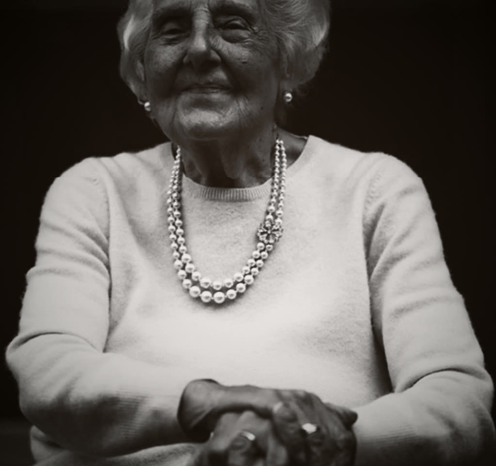 Violet smiling, wearing pearls